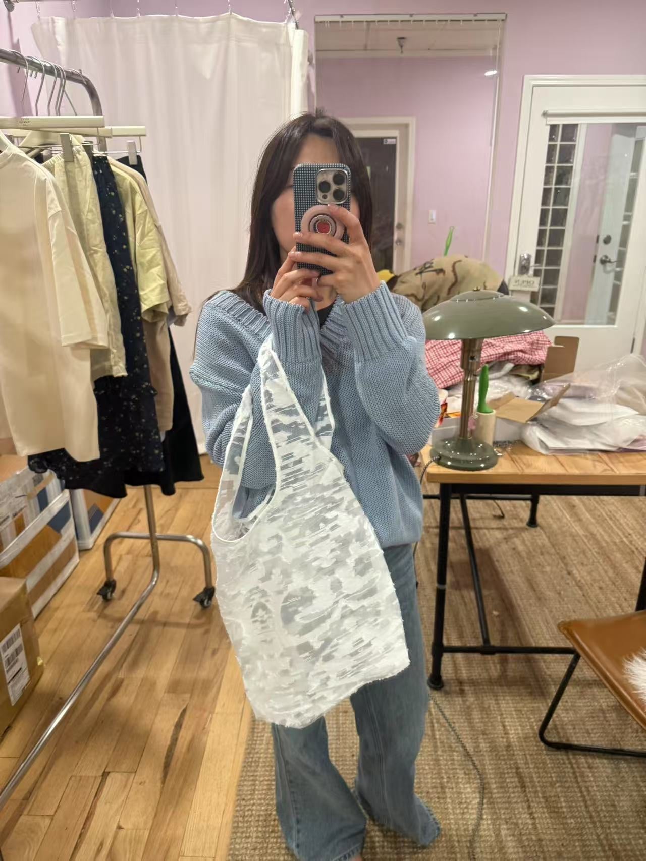 White handbag with three-dimensional flowers